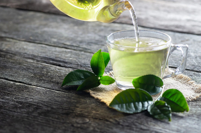 green-tea-being-poured-into-a-glass-cup-2048x.jpg