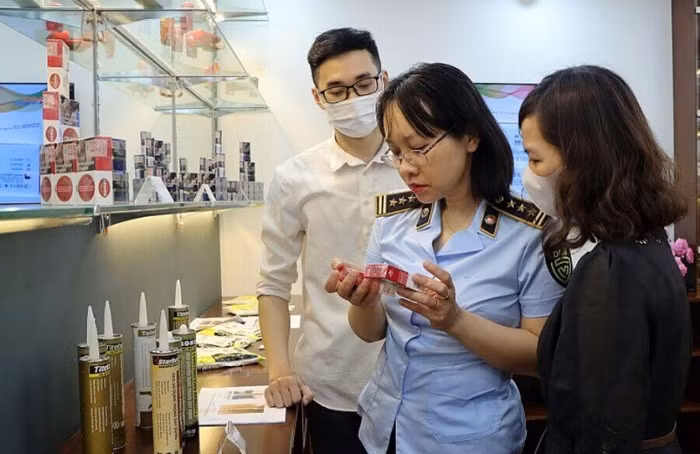 Lực lượng QLTT cùng người tiêu dùng đang nhận diện hàng thật và hàng giả