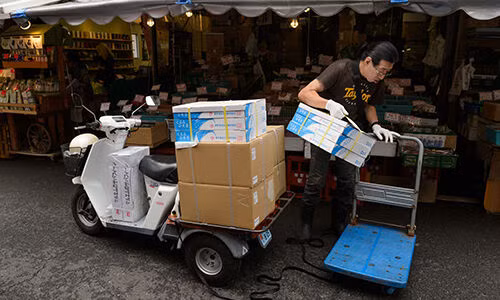 Ông Douko đã chở hàng bằng xe 50cc hơn 30 năm. Ảnh: Bloomberg