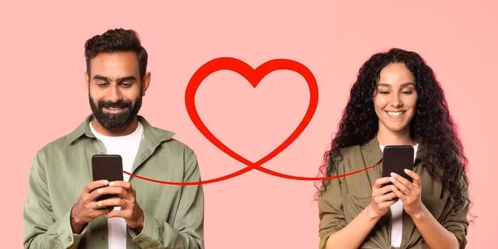 a-man-with-a-beard-in-an-olive-shirt-smiles-at-his-smartphone-and-a-woman-with-curly-hair-photo.jpg