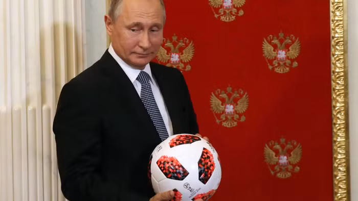 107089491-1657899120118-gettyimages-999375232-rus-russian-president-vladimir-putin-passes-symbolic-fifa-world-cup-baton-to-qatar-emir-tamim-bin-hamad-al-thani-at-the-kremlin.jpg